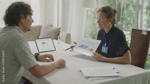 Wallpaper Mural Medium shot of female engineer explaining sustainable energy project on paper to male investor during business meeting Torontodigital.ca