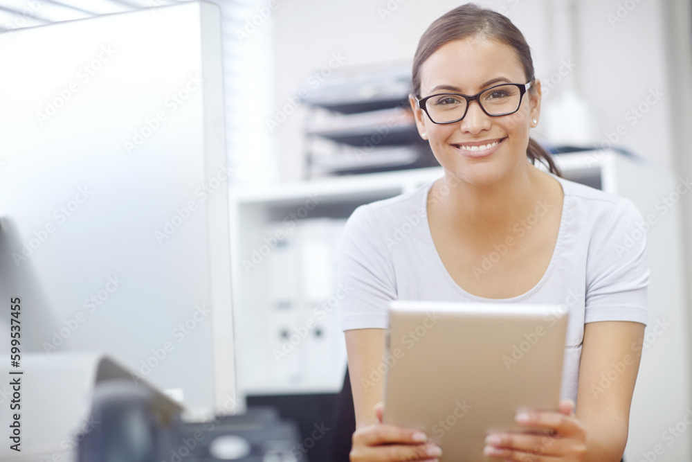 The smile of success. Portrait of an attractive young businesswoman using a digital tablet during work. The smile of success. Portrait of an attractive young businesswoman using a digital tablet during work.
