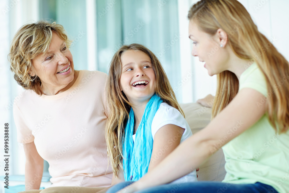 Just the girls. A cute young girl sitting inbetween her mother and grandmother smiling happily. Just the girls. A cute young girl sitting inbetween her mother and grandmother smiling happily.