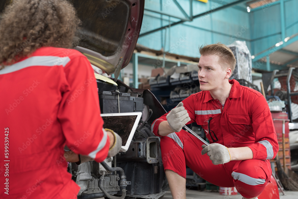 Car mechanic maintenance and auto service shop concept. Group of car mechanic repair, fix car engine in auto repair shop. Team of technician inspecting quality parts of battery, electronic in garage