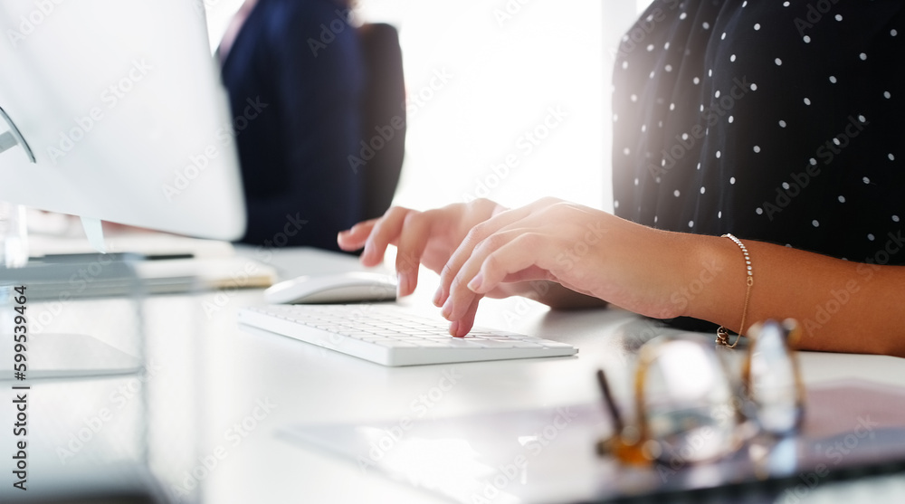 Productivity flies through her fingertips. businesswoman using a computer at her desk in a modern office. Productivity flies through her fingertips. businesswoman using a computer at her desk in a modern office.