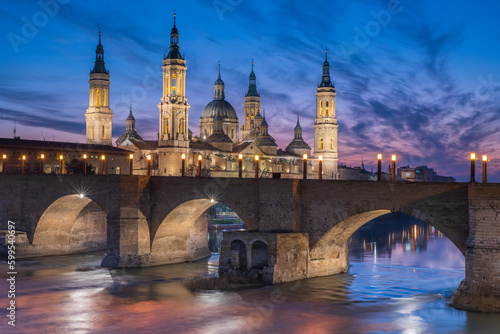 del Pilar basilica  one of the important architectural symbols of zaragoza  and the Ebro river and its reflection with sunset colors and clouds
