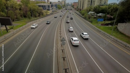 Almaty city, Al-Farabi avenue before rain, highway traffic in time lapse photo