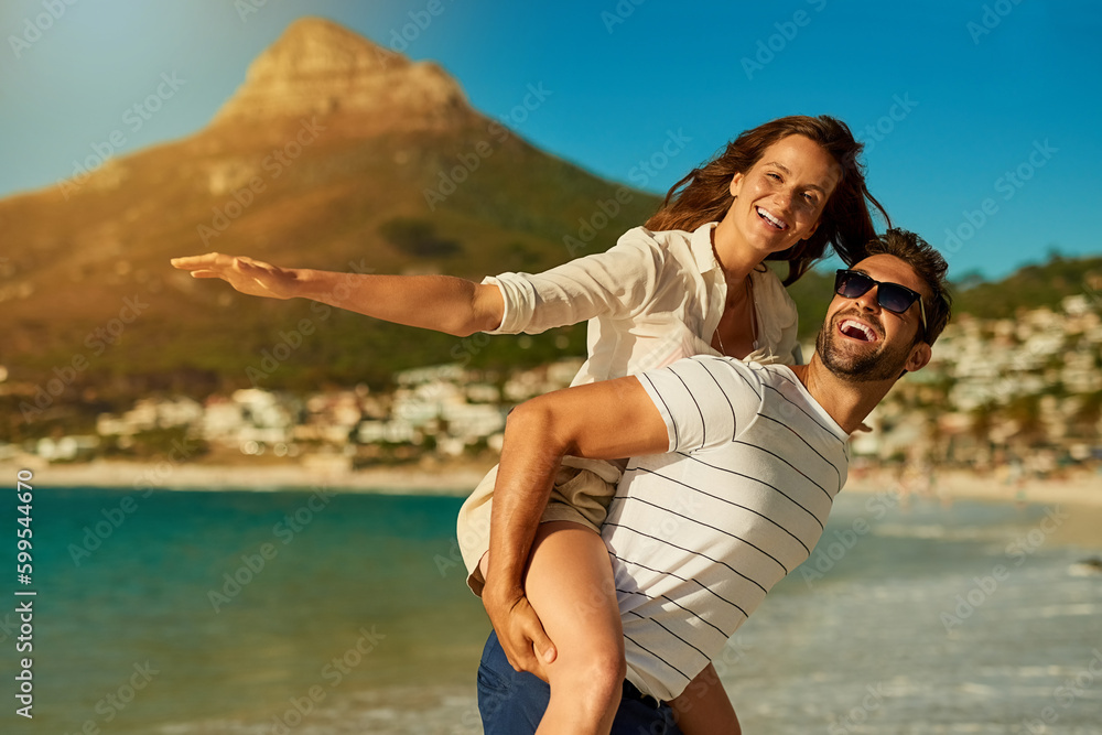 Free to just be. a happy young couple enjoying a piggyback ride at the beach. Free to just be. a happy young couple enjoying a piggyback ride at the beach.