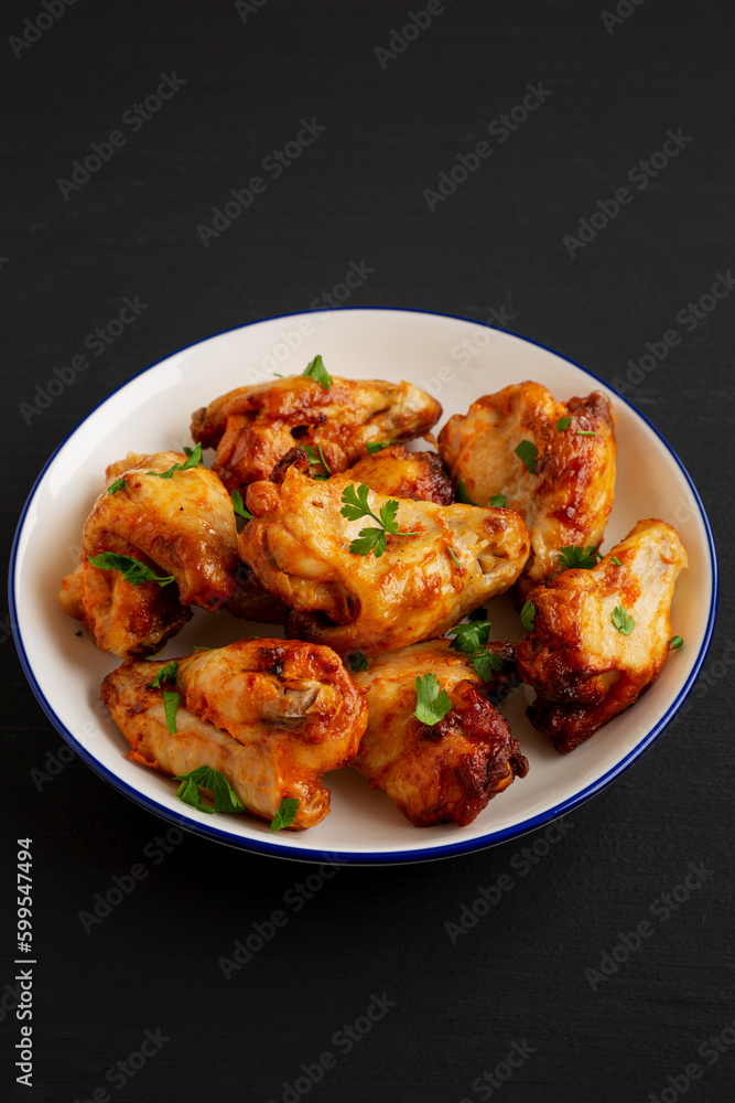 Homemade Grilled Chicken Wings with Parsley on a Plate, side view. Homemade Grilled Chicken Wings with Parsley on a Plate, side view.