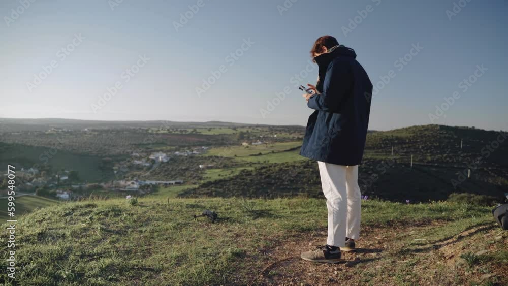 One Caucasian man taking off this drone from the ground One Caucasian man taking off this drone from the ground