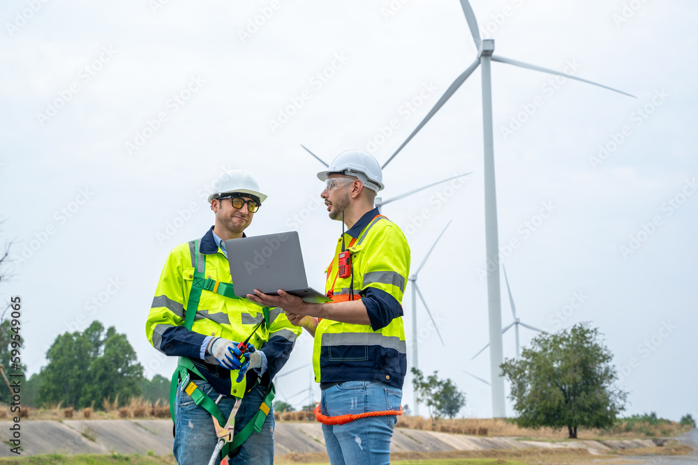 Engineer with technician are inspection work in wind turbine farms rotation to generate electricity energy. Engineer with technician are inspection work in wind turbine farms rotation to generate electricity energy.