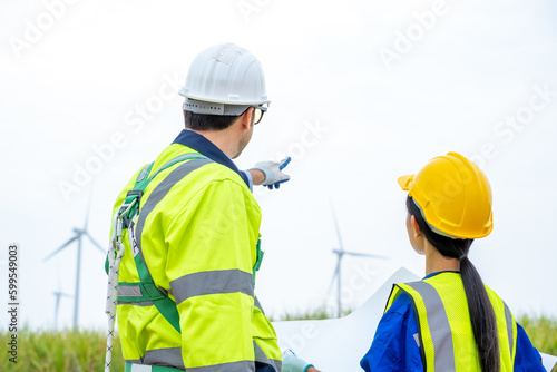 Wind turbine engineer,Engineer maintains and controls wind turbine energy generation on wind turbine farm,Concept of sustainable future.