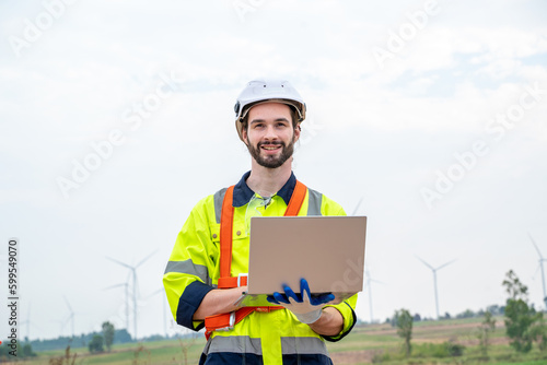 Engineer working at windmill farm,Generating electricity clean energy.