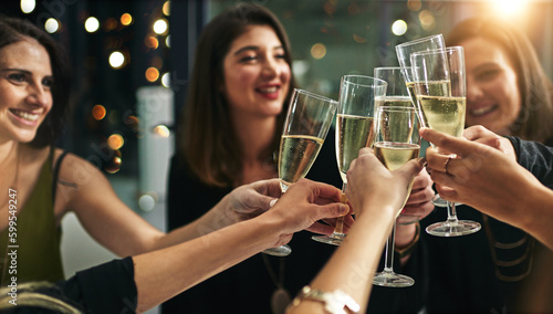 Toast, party and champagne with friends at restaurant for celebration, wine and social event. Happy, diversity and luxury with group of people drinking together for fine dining, cheers and free time