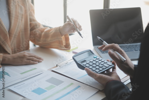 Financial analysts analyze business financial reports on a digital tablet planning investment project during a discussion at a meeting of corporate showing the results of their successful teamwork.