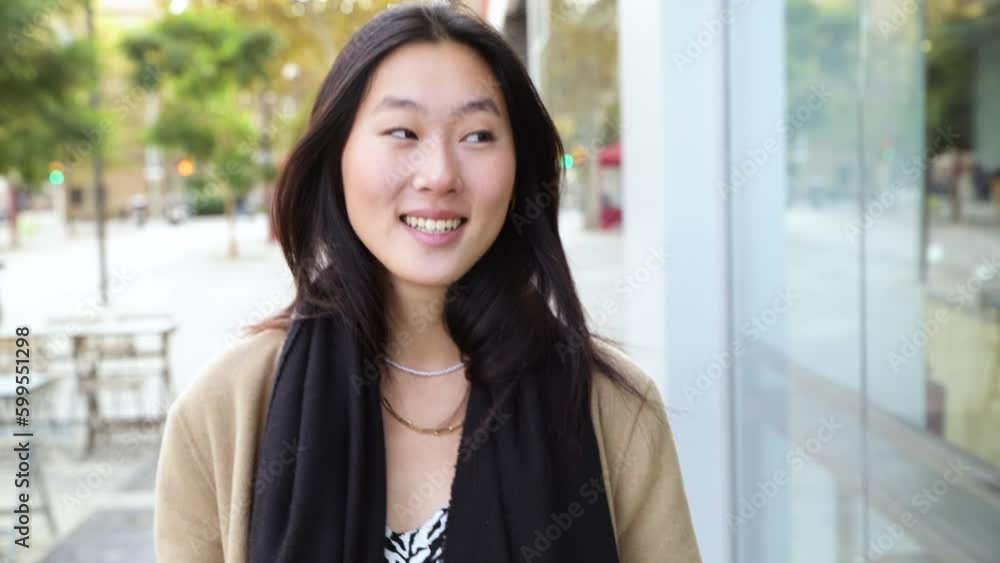 Beautiful happy young woman smiling confident and standing at the city - Portrait of young asian woman smiling happy standing at the city - Outdoor portrait of positive confident woman Beautiful happy young woman smiling confident and standing at the city - Portrait of young asian woman smiling happy standing at the city - Outdoor portrait of positive confident woman