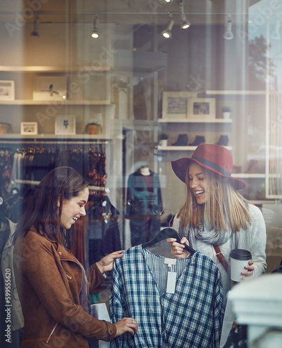 I just love the material. two best friends out shopping in a clothing store.