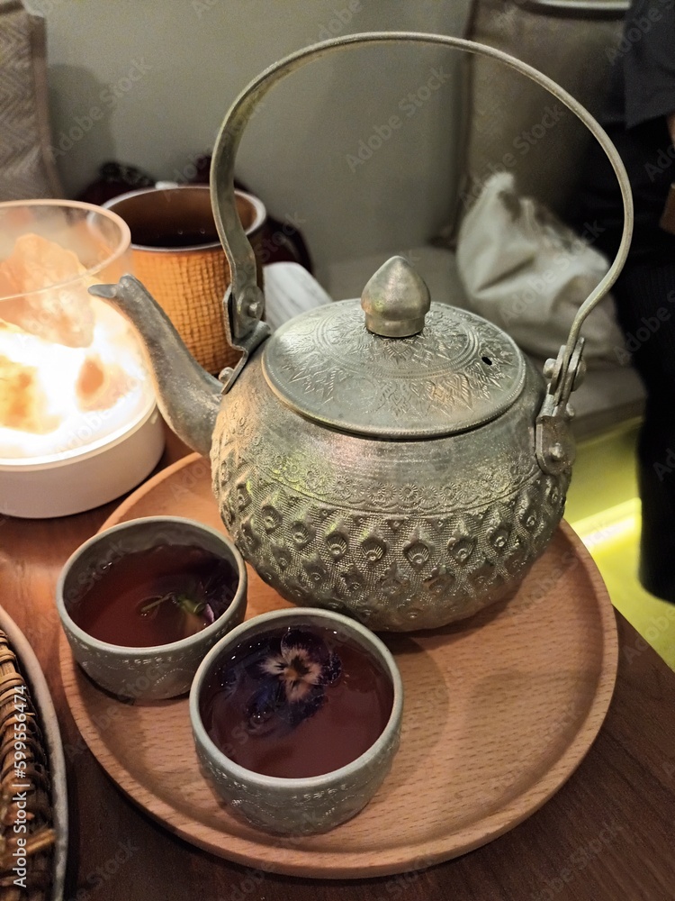 a tea set 2 tea cups with a teapot on a wooden tray a Thai drink/Thai beverage tea with edible
