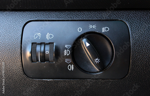 Light switch in luxury car. Modern car headlight controls. Car fog lights switch. Old car interior.