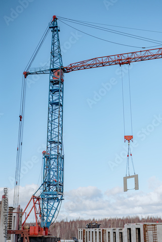 Crane lifting a building module to its position in the structure. Construction site of an residential building