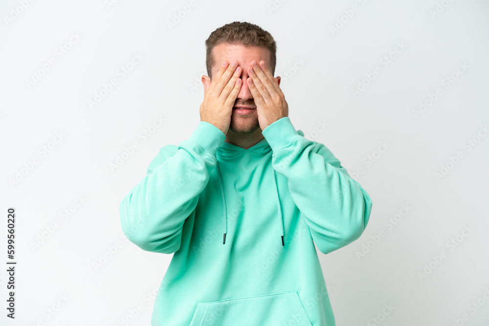 Young handsome caucasian man isolated on white background covering eyes by hands Young handsome caucasian man isolated on white background covering eyes by hands