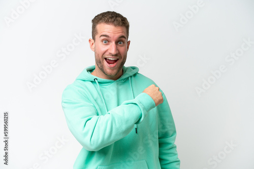 Young handsome caucasian man isolated on white background celebrating a victory