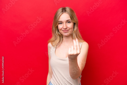 Young English woman isolated on red background making money gesture © luismolinero