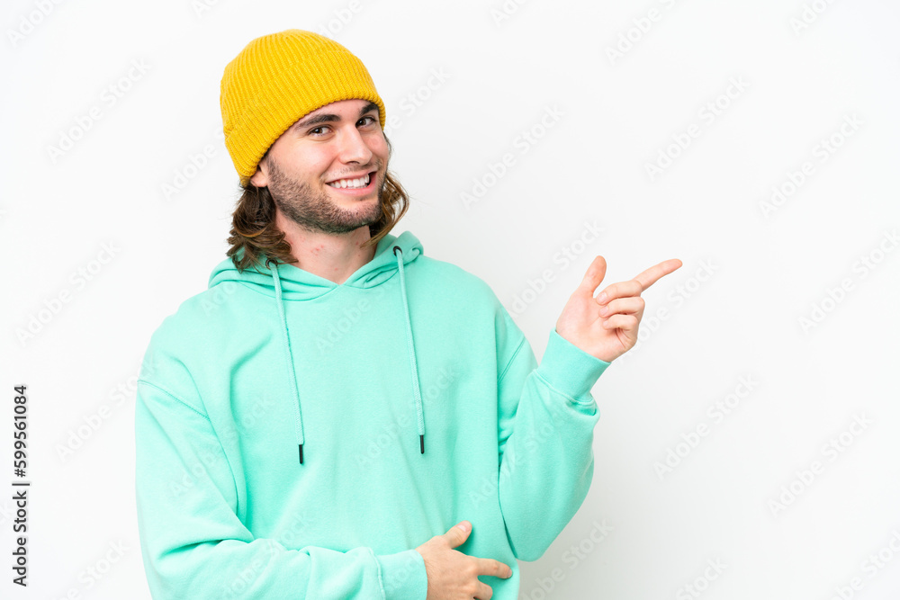 Young handsome man isolated on white chroma background pointing finger to the side Young handsome man isolated on white chroma background pointing finger to the side