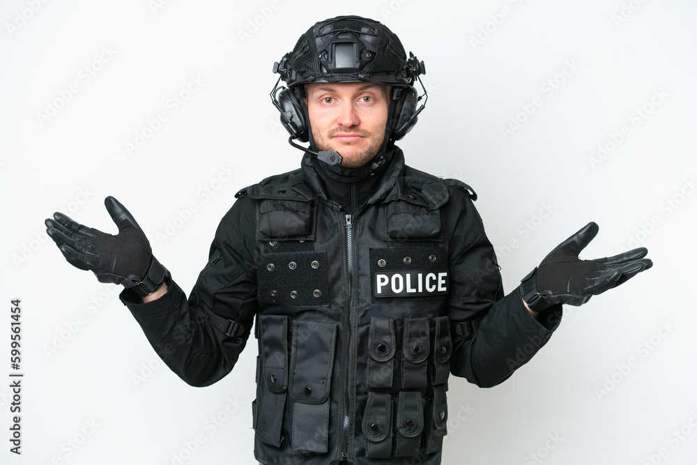 SWAT man over isolated white background having doubts while raising hands SWAT man over isolated white background having doubts while raising hands