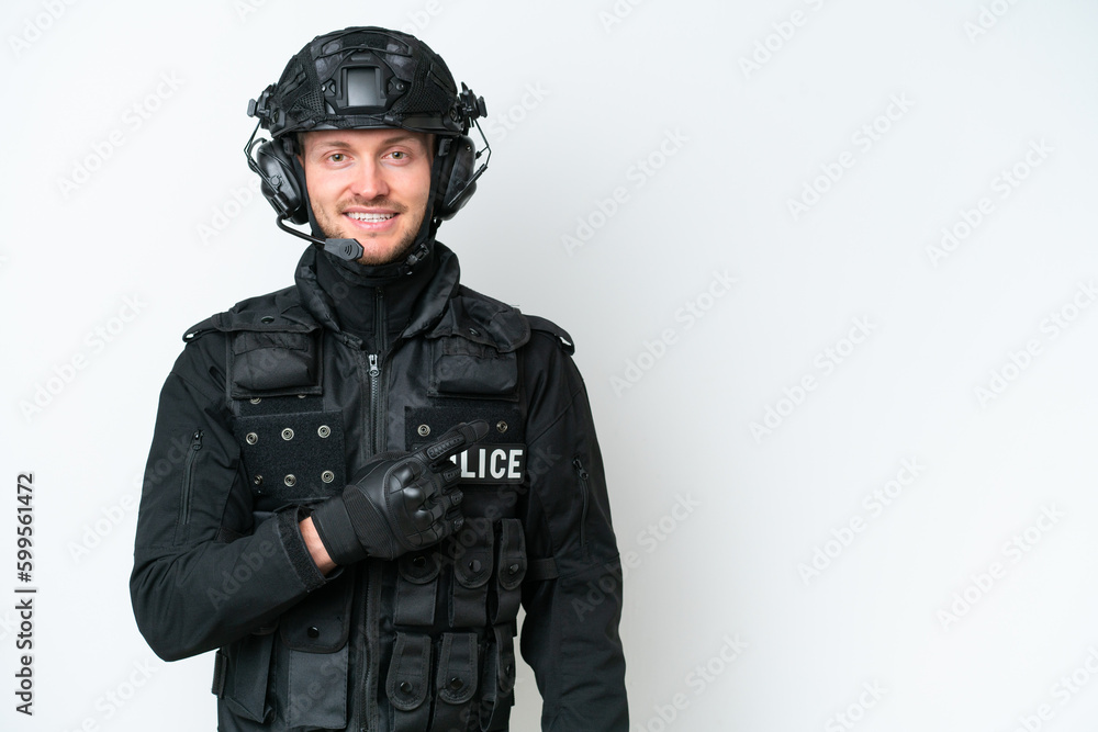 SWAT man over isolated white background pointing to the side to present a product SWAT man over isolated white background pointing to the side to present a product