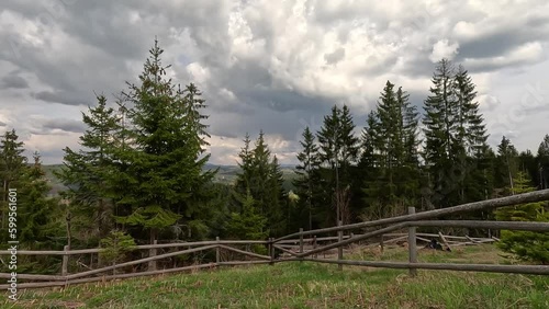 Beautiful landscape of sunny and cloudy spring day on Zlatar mountain in Serbia, houses, villages and natural idyllic pine forest, time lapse photo