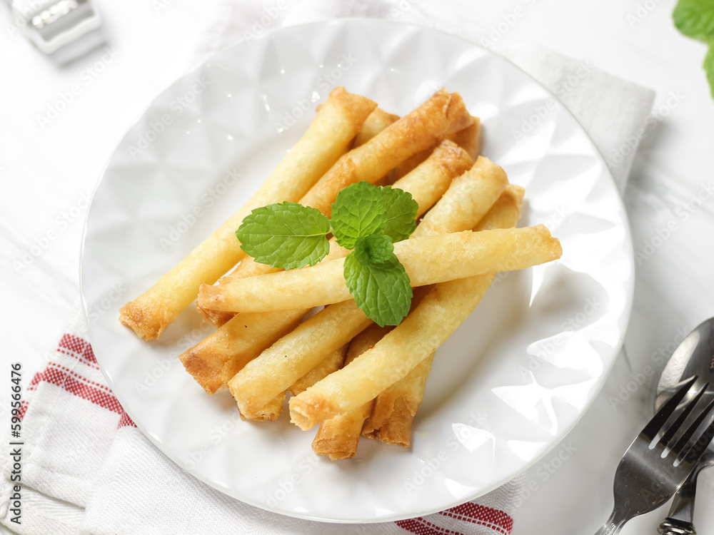 Crispy roll cheese in white plate. Crispy roll cheese is cheese that is cut and rolled with pastry skin. Crispy roll cheese in white plate. Crispy roll cheese is cheese that is cut and rolled with pastry skin.