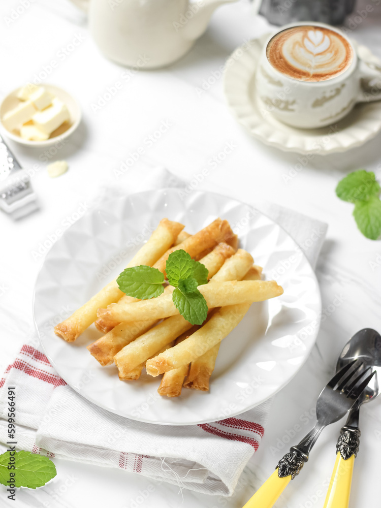 Crispy roll cheese in white plate. Crispy roll cheese is cheese that is cut and rolled with pastry skin. 