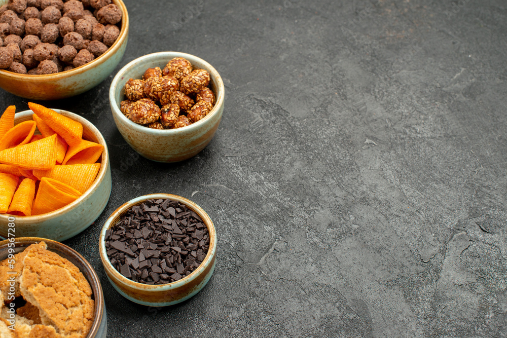 front view orange cips with sweet nuts and chocolate flakes on grey background meal snack breakfast nut front view orange cips with sweet nuts and chocolate flakes on grey background meal snack breakfast nut