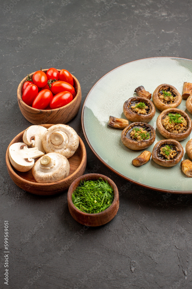 front view tasty mushrooms meal with fresh greens and tomatoes on a dark background dish dinner meal cooking mushroom front view tasty mushrooms meal with fresh greens and tomatoes on a dark background dish dinner meal cooking mushroom