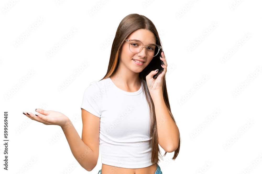 Teenager caucasian girl over isolated background keeping a conversation with the mobile phone with someone Teenager caucasian girl over isolated background keeping a conversation with the mobile phone with someone
