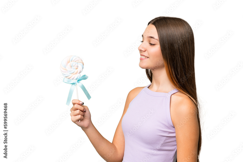 Teenager caucasian girl holding a lollipop over isolated background with happy expression Teenager caucasian girl holding a lollipop over isolated background with happy expression