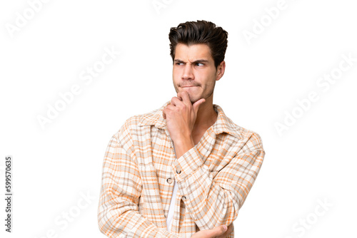 Young handsome caucasian man over isolated background having doubts and thinking