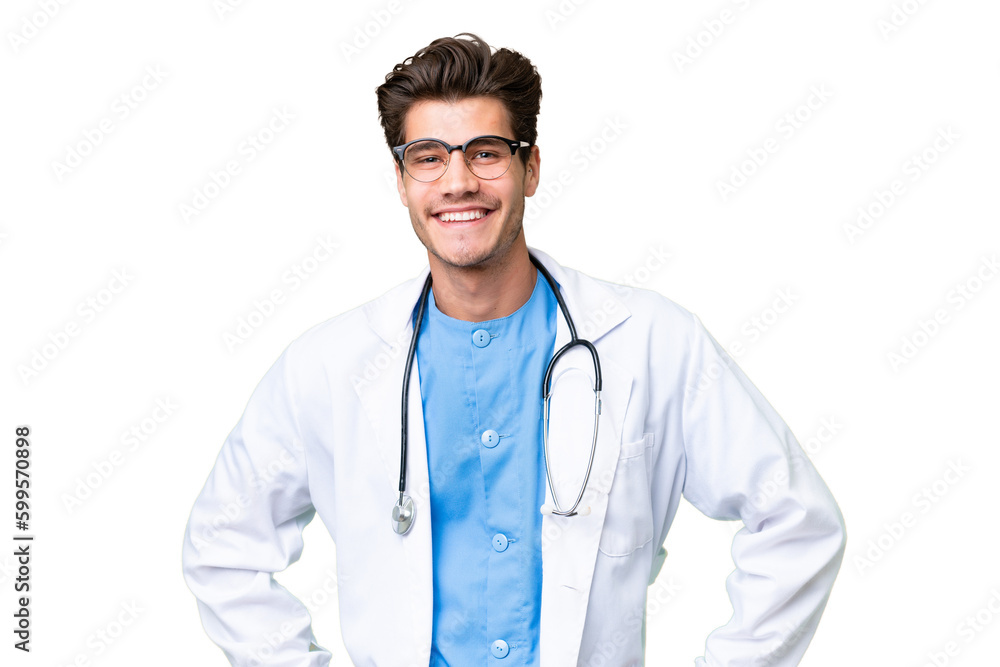 Young doctor man over isolated background posing with arms at hip and smiling