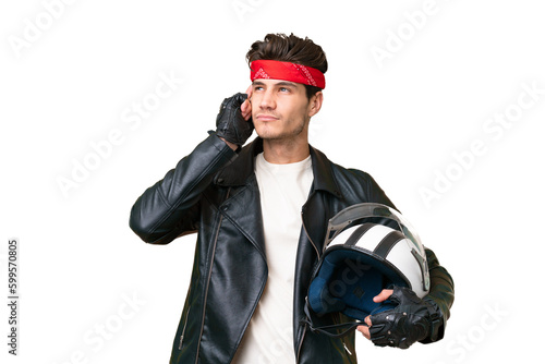 Young caucasian man with a motorcycle helmet over isolated background having doubts and thinking