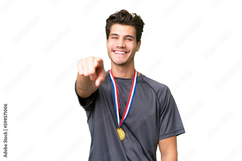 Young caucasian man with medals over isolated background points finger at you with a confident expression Young caucasian man with medals over isolated background points finger at you with a confident expression