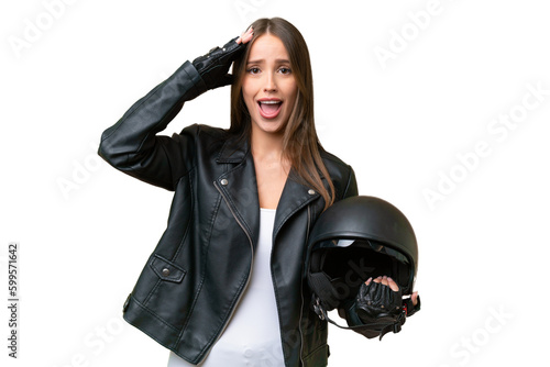 Young pretty caucasian woman with a motorcycle helmet over isolated background with surprise expression