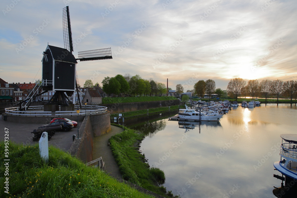 The old Harbor of Heusden, North Brabant, Netherlands, a fortified city located 19km far from Hertogenbosch, with a windmill and mooring boats