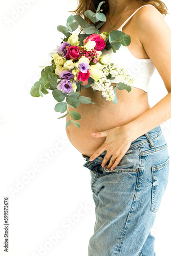 Fototapeta Naklejka Na Ścianę i Meble -  pregnant woman with flowers on a white background