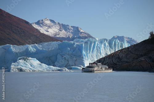 Gigantic Perito Moreno glacier in sunny day with mountain view as background at El Calafate, Patagonia, Argentina, South America. The popular destination of tourist.