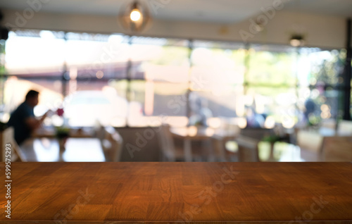 Empty dark wooden table in front of abstract blurred bokeh background of restaurant . can be used for display or montage your products.Mock up for space.