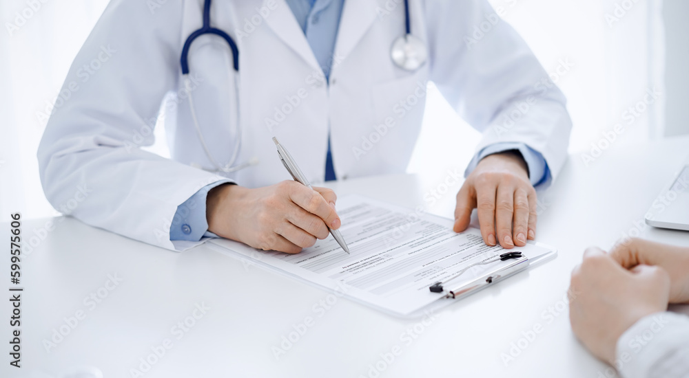 Stethoscope lying on the tablet computer in front of a doctor and patient sitting opposite each other at the background . Medicine, healthcare concept Stethoscope lying on the tablet computer in front of a doctor and patient sitting opposite each other at the background . Medicine, healthcare concept