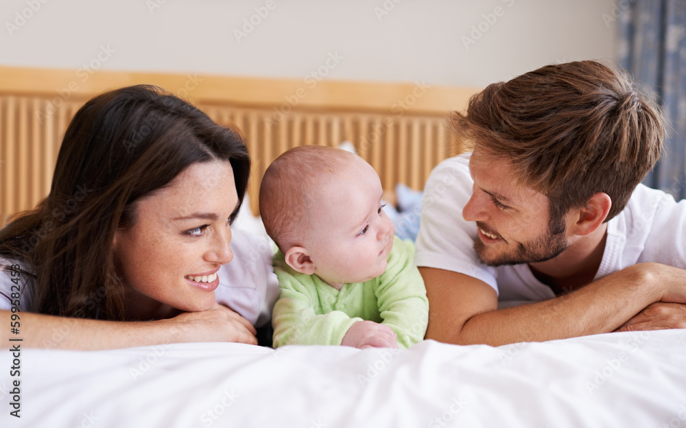 Happy family, mother and father with baby on bed for love, care and fun quality time together at home. Parents, cute newborn child and bonding to relax in bedroom for support, nurture and happiness Happy family, mother and father with baby on bed for love, care and fun quality time together at home. Parents, cute newborn child and bonding to relax in bedroom for support, nurture and happiness