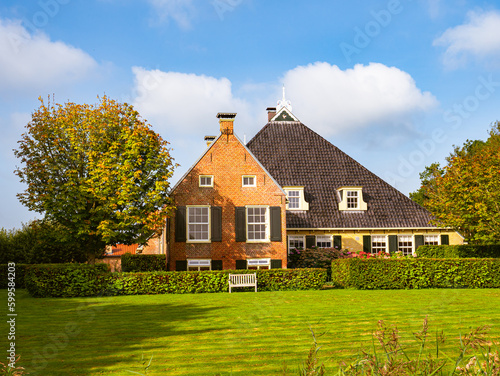 Frisian farmhouse in autumn near Langweer, Friesland, Netherlands photo