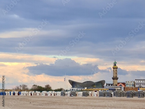View from the beach to the skyline of Warnemunde with the old lighthouse and the famous restaurand 