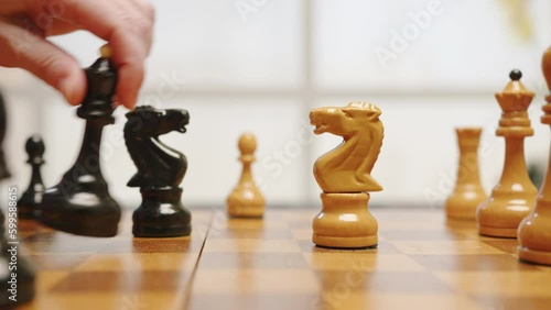 Chess game on wooden chessboard close-up. People play chess tournament.