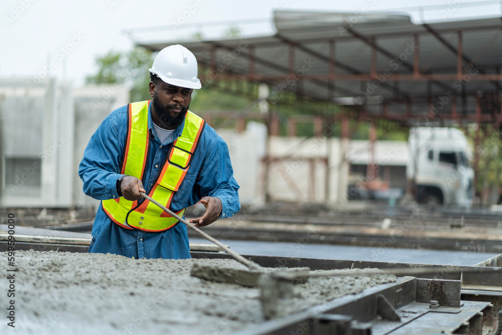 Male worker in a precast wall factory (Precast) is forming a wall with cement. and smooth the plaster in the prepared mold Male worker in a precast wall factory (Precast) is forming a wall with cement. and smooth the plaster in the prepared mold