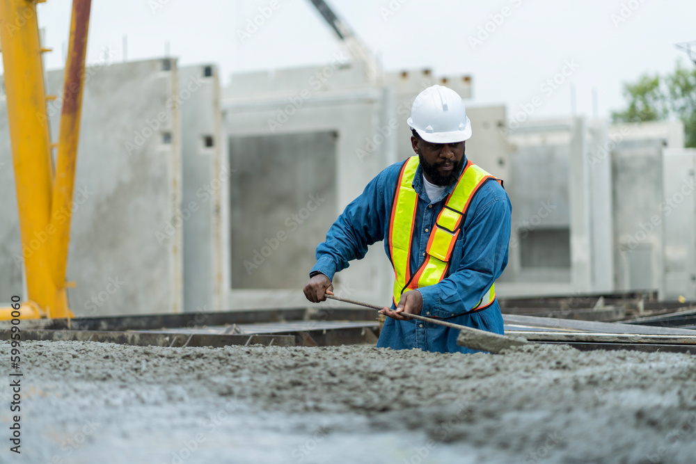 Male worker in a precast wall factory (Precast) is forming a wall with cement. and smooth the plaster in the prepared mold