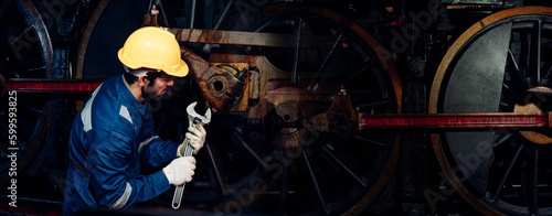 Engineer railway wearing safety uniform and helmet under checking under train ,wheels and control system for safety travel passenger. Banner cover design. © kelvn